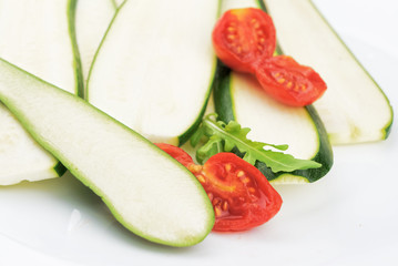 Fresh green zucchini on white plate