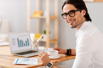 Handsome smiling man sitting at the table