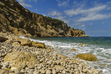 Waves crash against the boulders on the balearic islands.
Spain,Ibiza,Summer