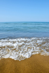 Fototapeta na wymiar Blue sea with sandy beach in sunny day.