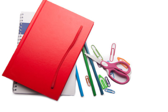 red notebook and school supplies
