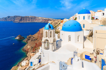 Fototapeta na wymiar View of famous Oia village with blue domes of church buildings, Santorini island, Greece