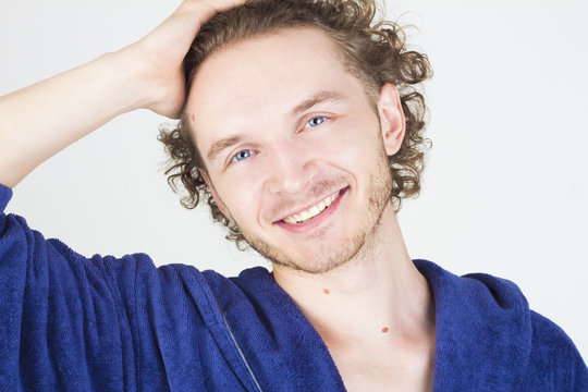 Handsome Young Man Smiling With Teeth And Touching His Hair. Portrait Of Man Close-up.