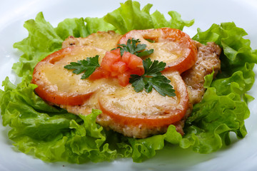 Pork baked with tomato and cheese