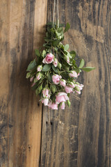 Bouquet of Pink Roses on a Rustic Background of a Board