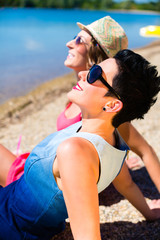 Women relaxing at lake beach