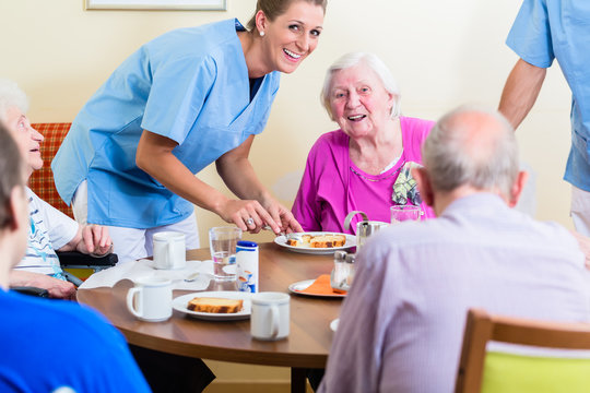Group of seniors having food in nursing home