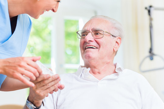 Nurse giving senior man prescription drugs