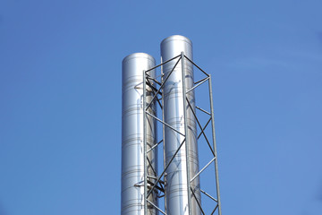 smokestacks with blue sky background
