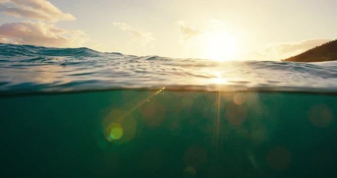 Beautiful blue ocean sunset, over under split view of sunset sky and underwater