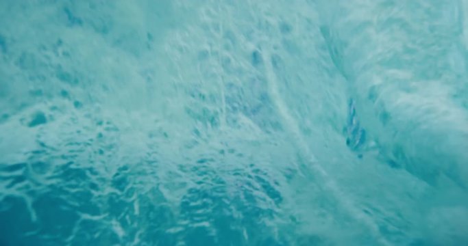Beautiful blue ocean wave breaking in slow motion