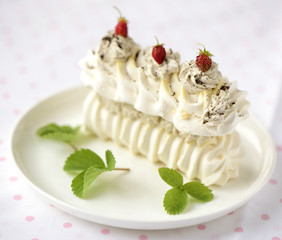 meringue cake with fresh berries on white background