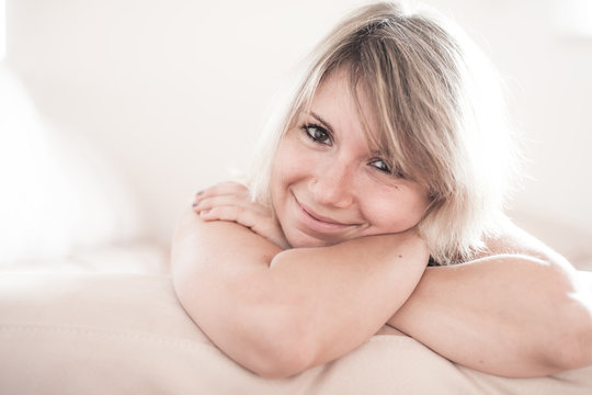 Cute young girl relaxing on couch at home. Hi key Softfocus Imag