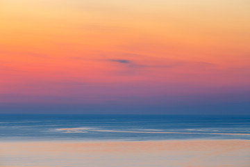 sunset over the mountain with reflection on the sea