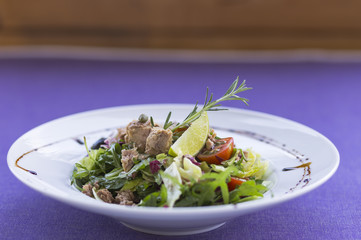 Tuna salad with vegetables on the plate.