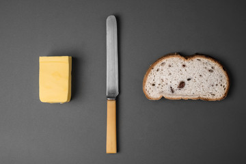 Bread and butter - knife, butter and bread viewed from above