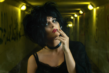 Freaky woman with black hair smoking a cigarette
