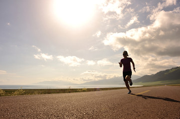 healthy lifestyle young woman runner running on sunrise seaside