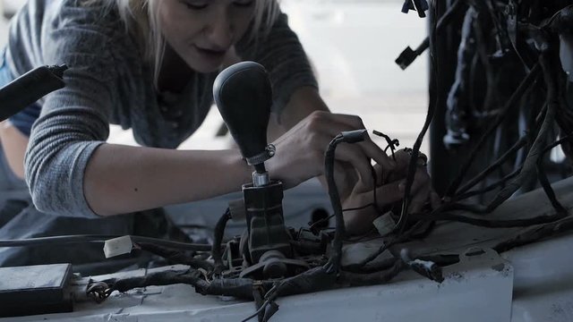 Attractive woman rummaging in the naked car