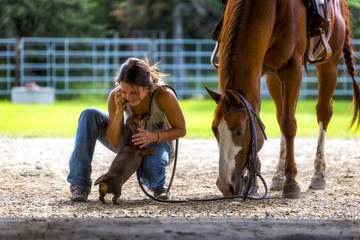 Farm girl on phone with horse and dog