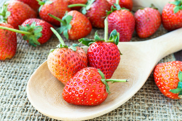 Fresh strawberry on wooden ladle