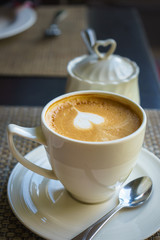 Heart shape in white cup coffee