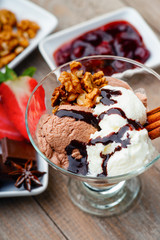 Ice cream sundae, chocolate, walnuts and sliced strawberry
