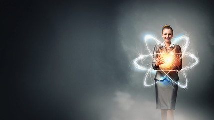 Woman scientist presenting atom research concept . Mixed media