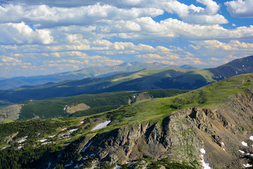 Colorado Mountain Range Vista  In Summer with Pine Trees and Snow on a Sunny Day