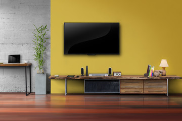 Living room led tv on yellow wall with wooden table 