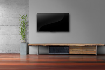 led tv on gray wall with wooden table in livg room