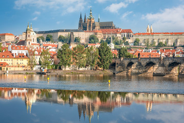View over river Vltava and Charles bridge to Prague castle with copy space in clear sky
