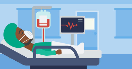 Patient lying in hospital bed with heart monitor.