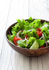 Vegetable salad with fresh lettuce, tomatoes and cucumber
