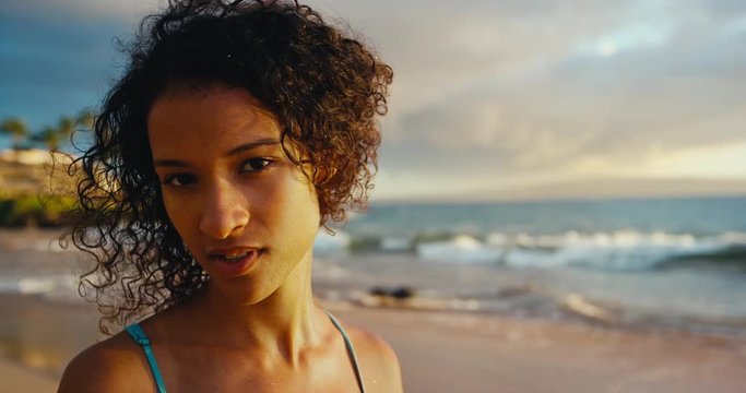 Portrait of beautiful young african american woman on the beach at sunset, soft warm vintage color tone