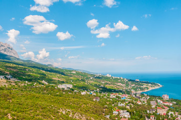 Fototapeta na wymiar beach at the seaside, blue water, view from above the mountains to the town of Simeiz, Yalta, Crimea