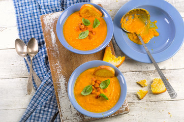 Carrot soup with toasts and herbs.