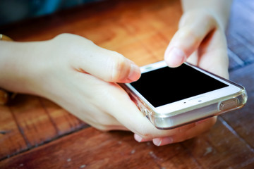 2 Hands holding mobile smart phone with blank screen.