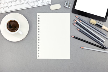 office table with blank paper sheet, keyboard, pencils and table