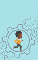 Businessman running inside the gear.