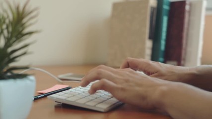 Young female secretary working at computer, answering calls in the office. Concept of multitasking and mobility.  
