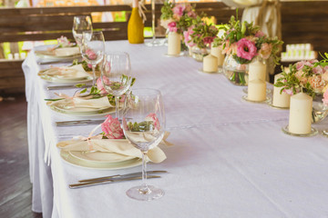 flower composition and candles in the restaurant. Wedding dinner