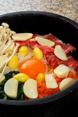 Rice with beef and vegetable in hot bowl Korean food