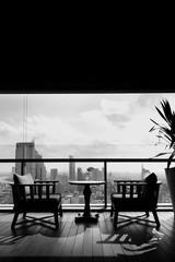 two chair at terrace restaurant with city view background