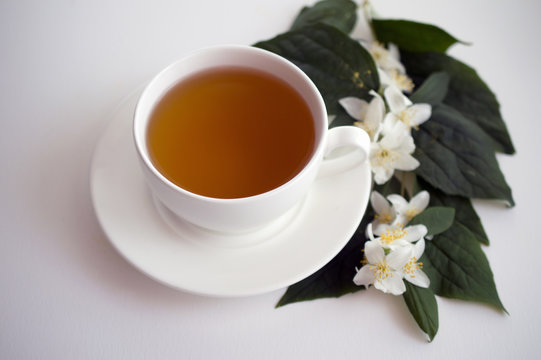 cup of tea and jasmine flowers