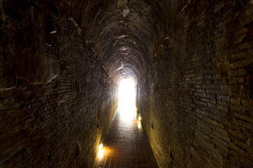 Walkway tunnel made by red brick and middle white isolated space