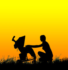 Obraz premium Silhouette of a woman with a baby stroller at sunset