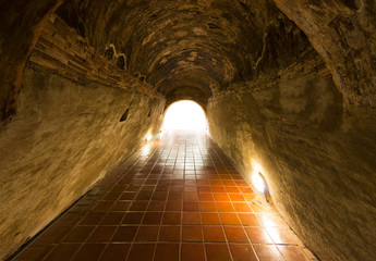 Walkway tunnel made by red brick and middle white isolated space