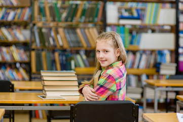 Teen girl embracing book in the library