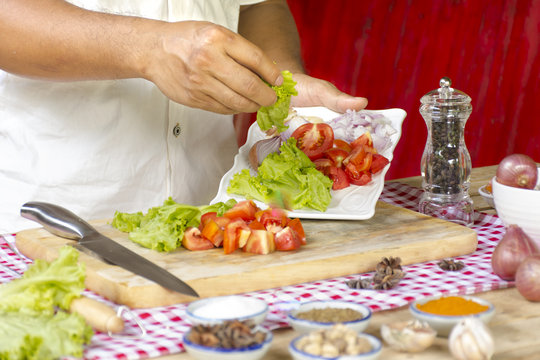 Man cooking and raw food and ingredient on table